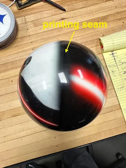 Phone photo of the same ball, seen from above